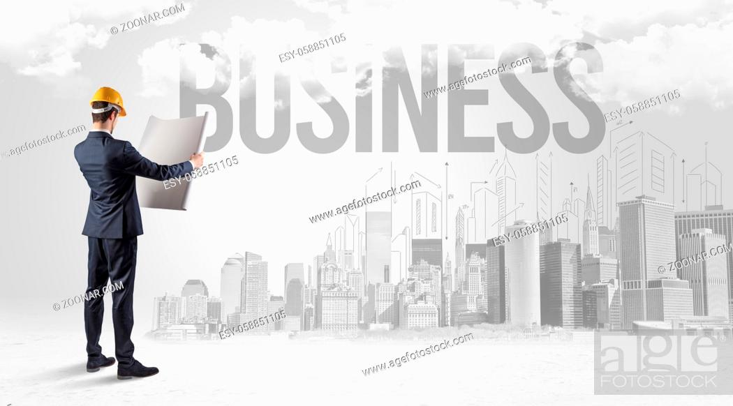 Stock Photo: Young businessman with hard hat and BUSINESS inscription, new business opportunity concept.