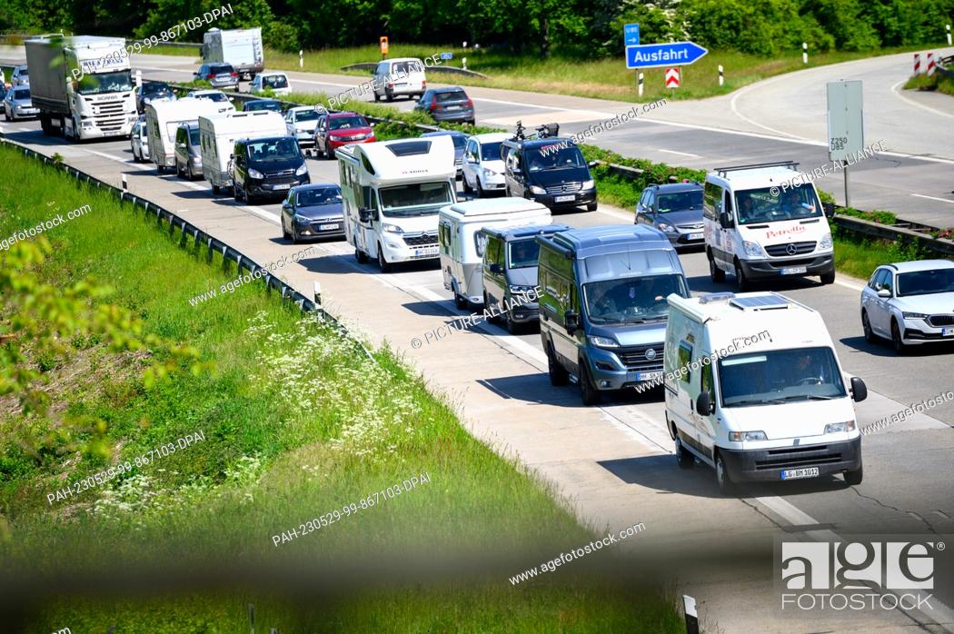 Stock Photo: 29 May 2023, Schleswig-Holstein, Ratekau: Numerous motorhomes and cars are stuck in traffic jams on the A1 autobahn. For the Whitsun weekend.