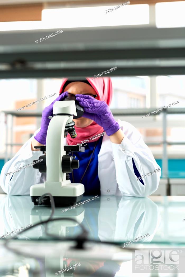 Stock Photo: muslim lab worker doing an analysis.