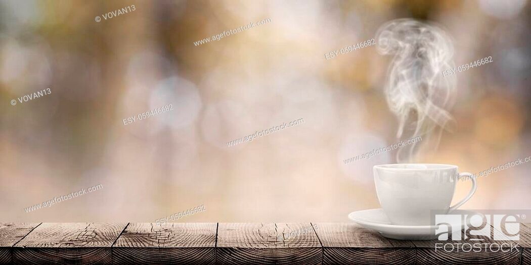 Stock Photo: hot coffee on the table on a blur background.