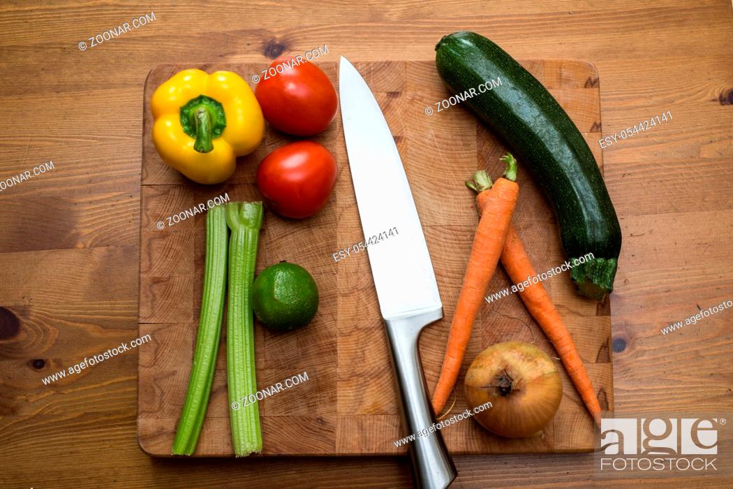 Stock Photo: fresh vegetables on the cutting board and knife onion, tomatoes, carrot lemons., paprika, on wood background healthy.