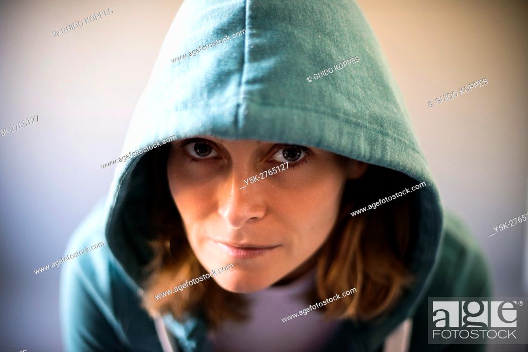 Stock Photo: Tilburg, Netherlands. Studio portrait of a mid adult caucasian female wearing a hoody.