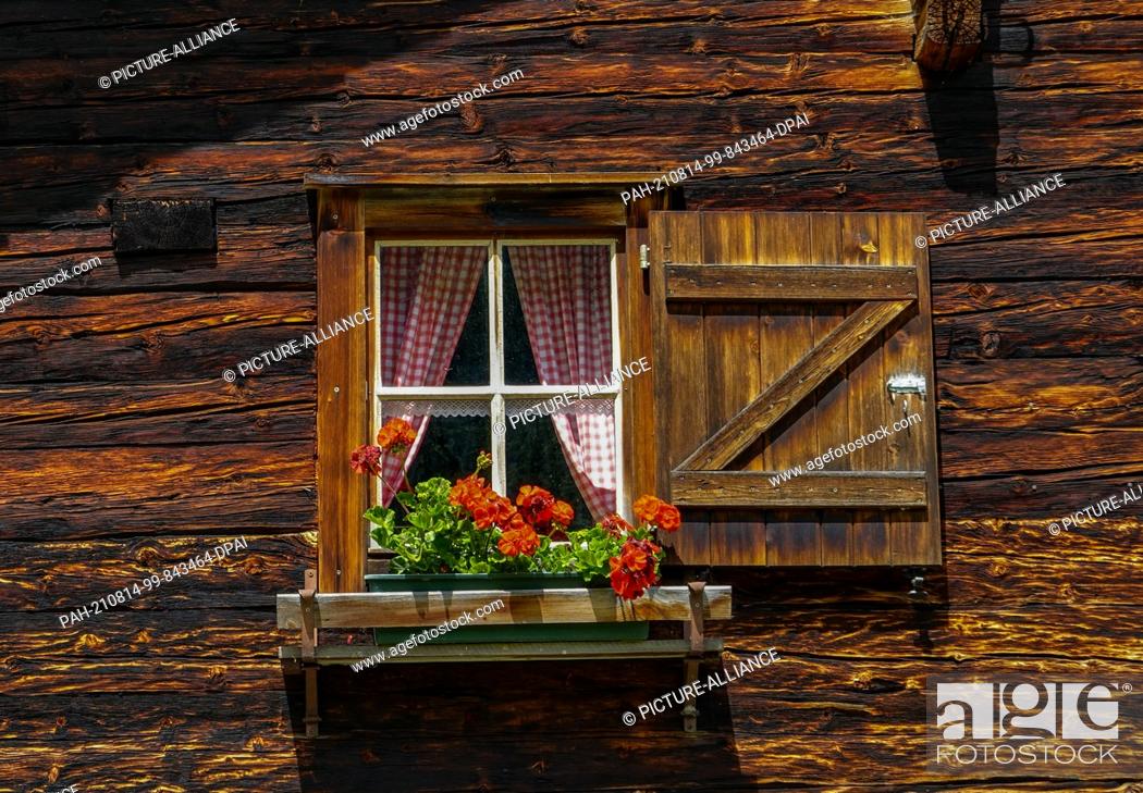 Stock Photo: 22 July 2021, Austria, Sankt Jakob: A window of the Patscher Hut in the Patscher Valley near the Defereggen Valley in Tyrol.