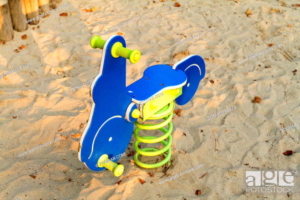 Stock Photo: Photo of a blue rocking horse in the playground.