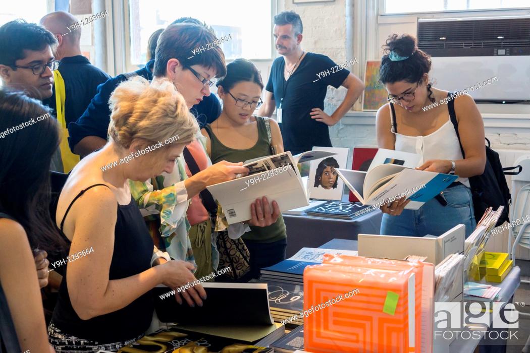 Stock Photo: Visitors browse an exhibitor's booth at Printed Matter's 9th annual NY Art Book Fair located in MoMA PS1 in New York. The 3-day event showcases artists' books.