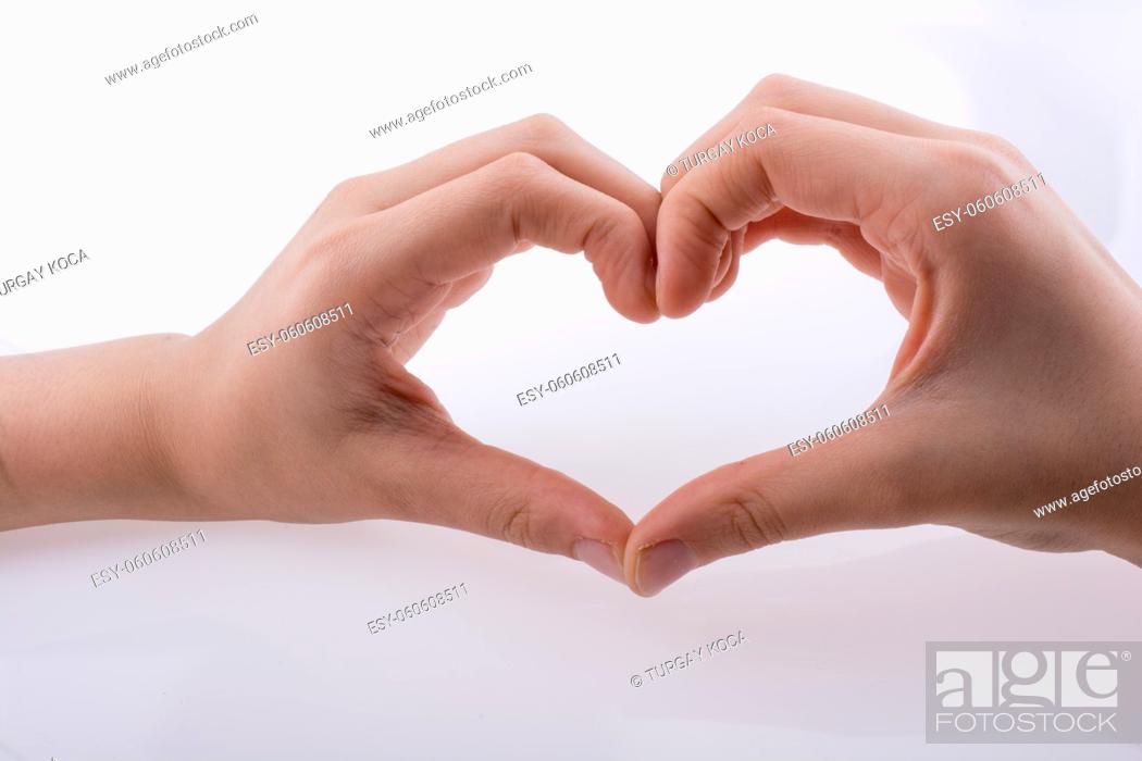 Stock Photo: Hand making a heart shape on a white background.