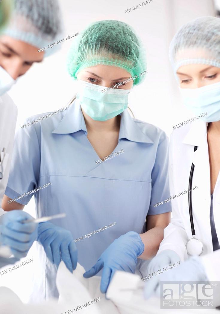 Stock Photo: healthcare and medical - young group of doctors doing operation.