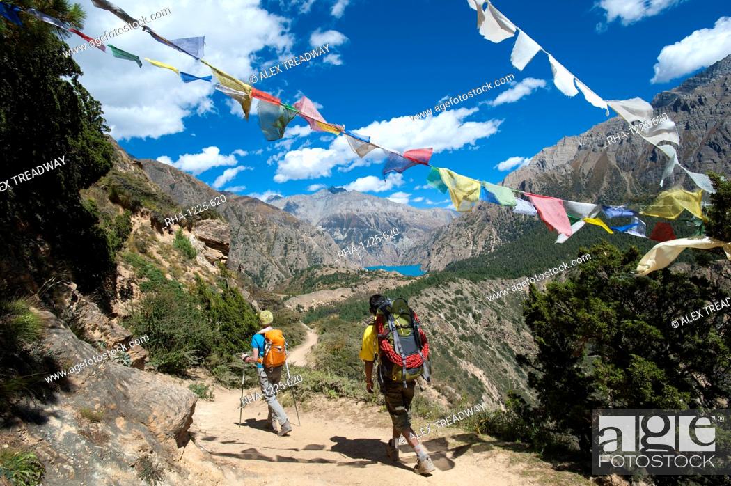 Stock Photo: Prayer flags mark a high point in the trail where trekkers are rewarded with their first glimpse of Phoksundo Lake, Dolpa Region, Himalayas, Nepal, Asia.