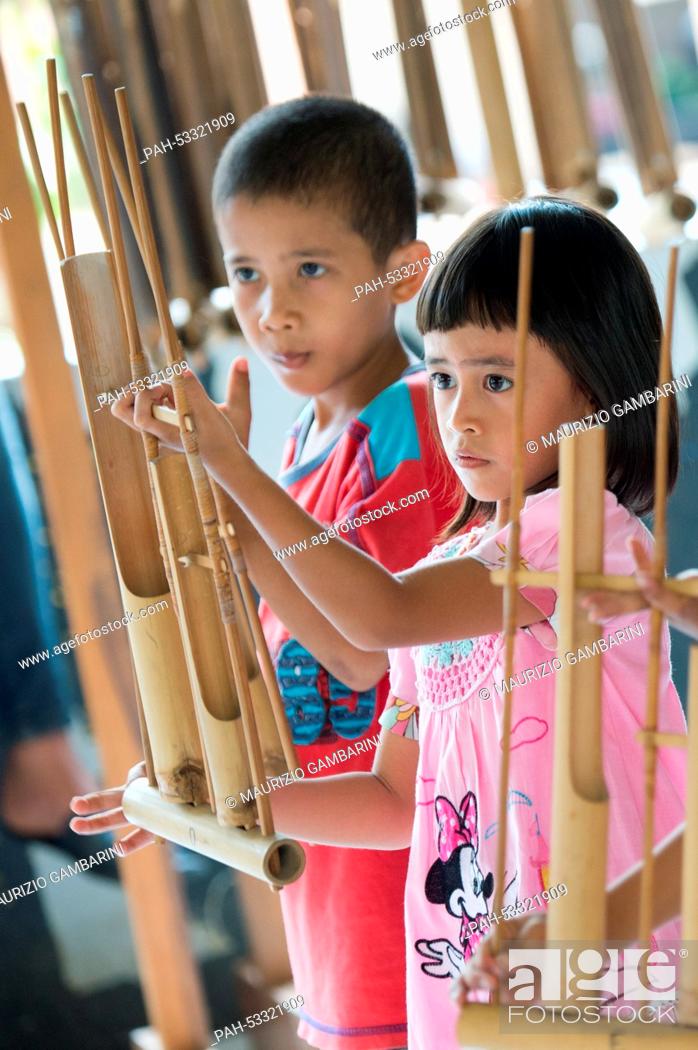 Stock Photo: Former street kids play with Indonesian musical instruments in Jakarta,  Indonesia, 03 November 2014. Actress Natalia Woerner supports Kindernothilfe.
