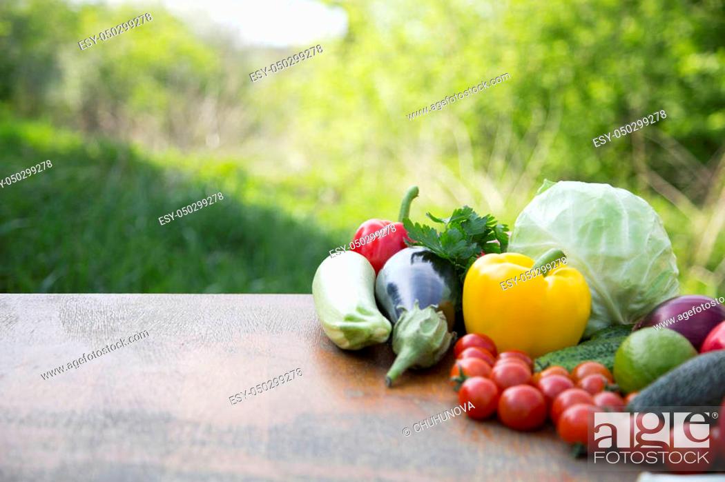 Stock Photo: Set of organic vegetables and fruits on rustic wooden table and blur background. Copy space.