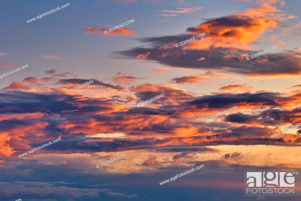 Stock Photo: Autumn sky before dawn, the first rays of sunlight color the sky with clouds. Background, texture, space for text.