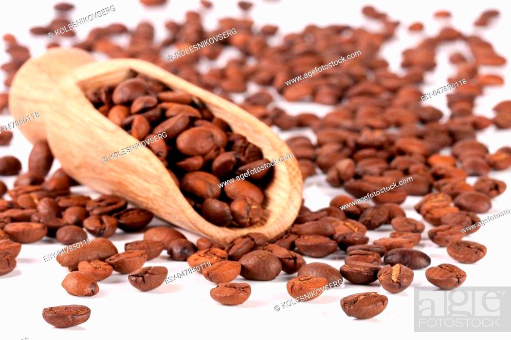 Stock Photo: coffee beans in a wooden scoop isolated on white background.
