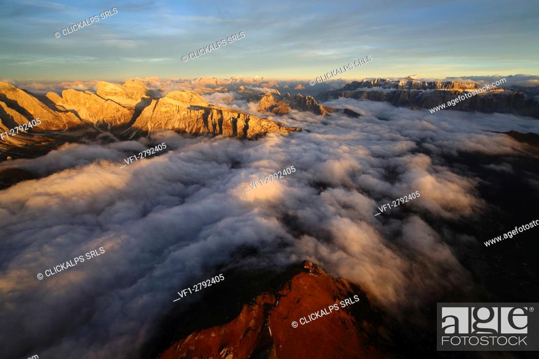 Stock Photo: Aerial shot of Sella Group Alps surrounded by clouds at sunset. Dolomites Trentino Alto Adige. Italy Europe.