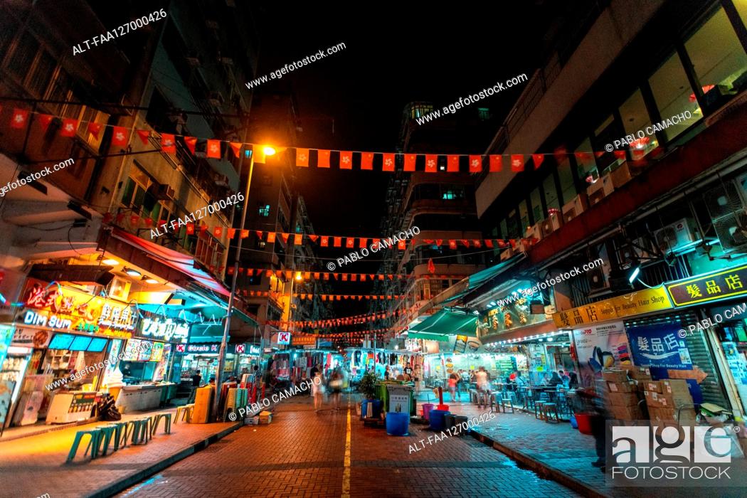 Photo de stock: Hong Kong and China flag bunting hanging across street.