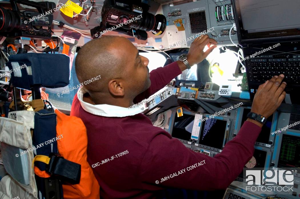 Stock Photo: Astronaut Robert L. Satcher Jr., STS-129 mission specialist, occupies the commander's station on the flight deck of Space Shuttle Atlantis during flight day two.
