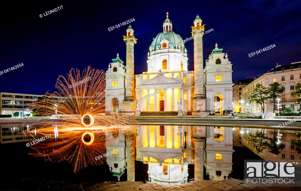 Stock Photo: Magical evening view of the St. Charles Church (Karlskirche) and fire show. Historical scene, famous tourist attraction. Location place Karlsplatz in Vienna.