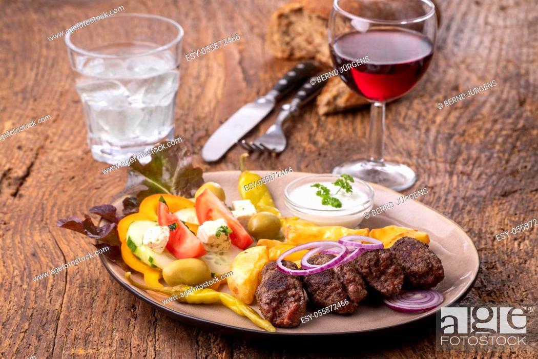 Stock Photo: cevapcici on a plate with french fries.