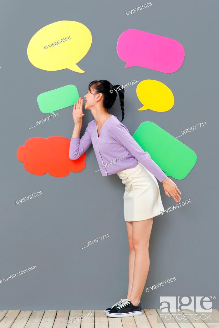 Stock Photo: Happy girl standing in front of the dialog box.
