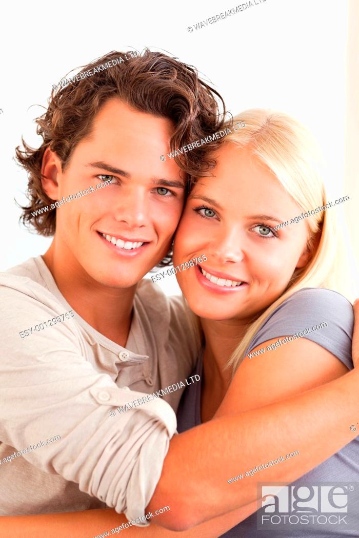 Stock Photo: Portrait of a couple embracing each other while looking at the camera.