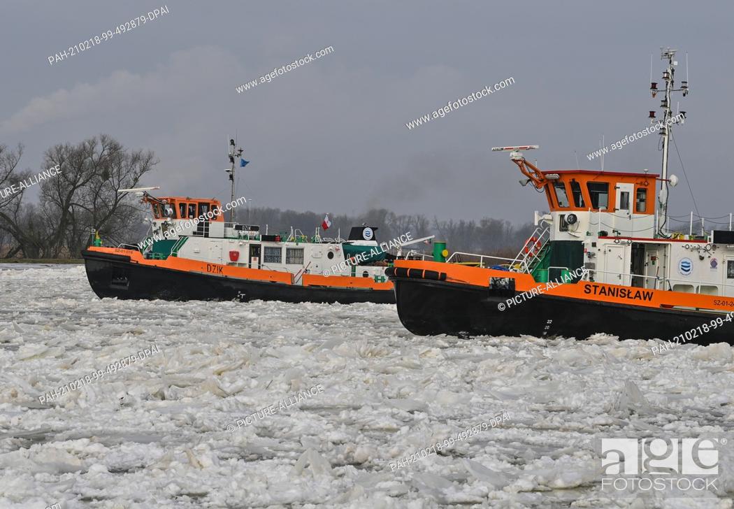 Stock Photo: 18 February 2021, Poland, Zatan Dolna: Two Polish icebreakers are sailing on the German-Polish border river Oder north of Schwedt (Brandenburg).
