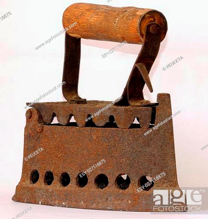 Stock Photo: Antique - antique iron, with the handle on top of a main body used for ironing, which crawled in the hot coals.