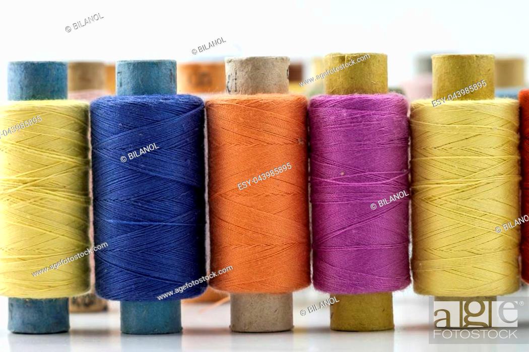 Stock Photo: Reels or spools of multicolored sewing threads. Threads of all colors. Shallow depth of field. Close-up macro shot.