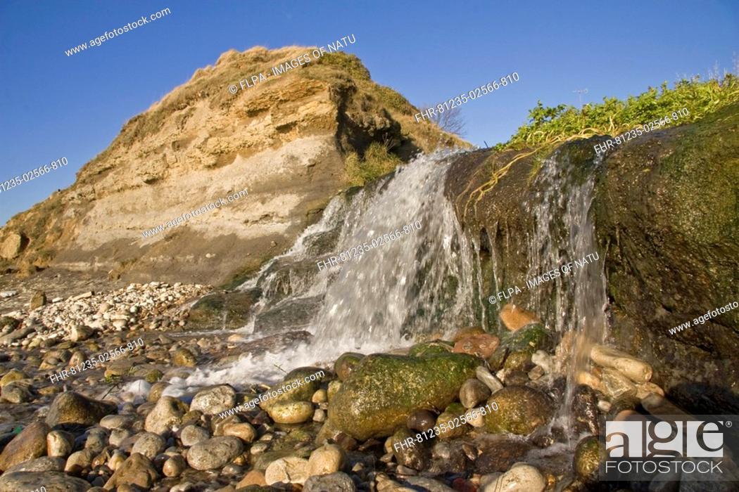 Stock Photo: Small freshwater cascade, flowing onto beach, Osmington, Dorset, England, december.
