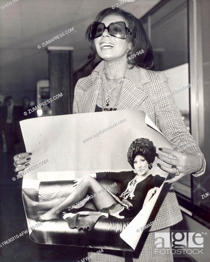 Stock Photo: Mar. 10, 1963 - London, England, U.K. - Singer SHIRLEY BASSEY shows off picture by Lord Snowdon upon arrival at Heathrow Airport.