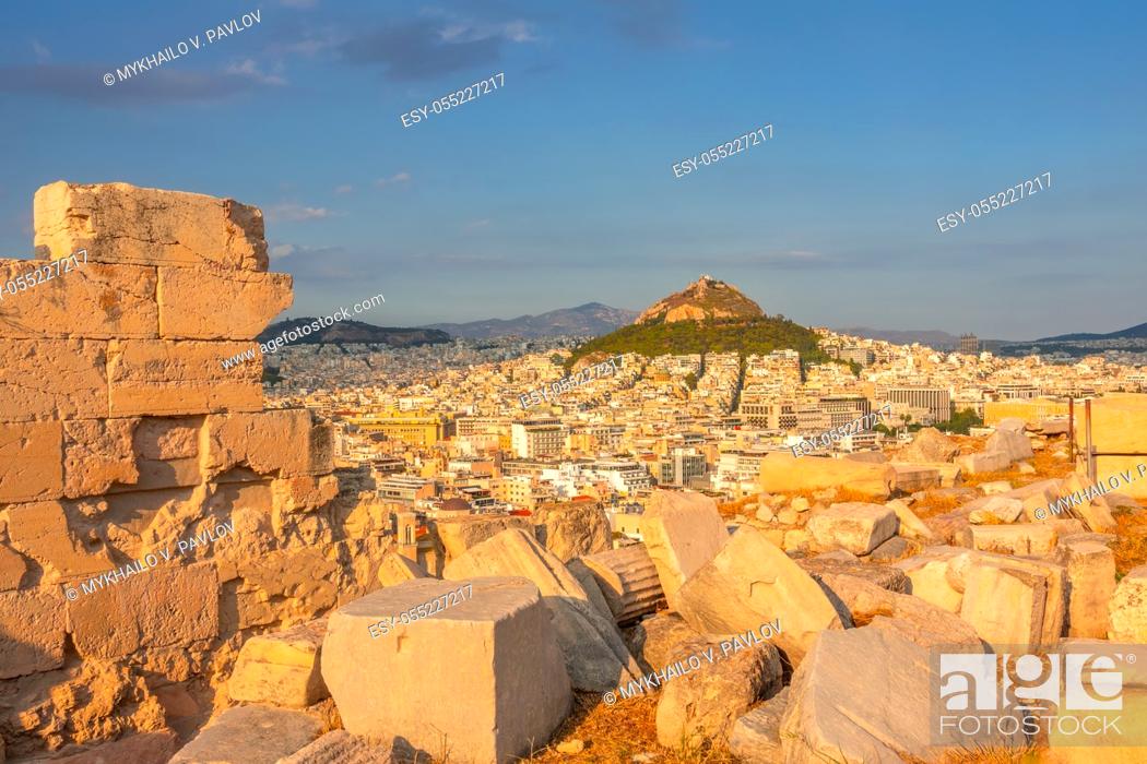 Stock Photo: Greece. Sunset in Athens. Marble ruins in the foreground. View from a high point on city rooftops and Lycabettus hill.