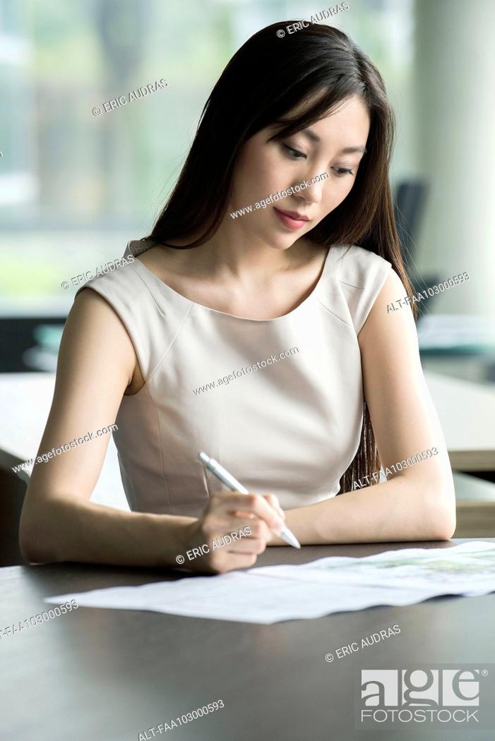 Stock Photo: Office worker doing paperwork.