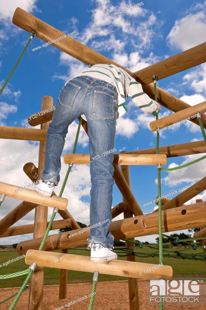 Stock Photo: A  picture of an eleven year old boy on a climbing frame in the Uk.
