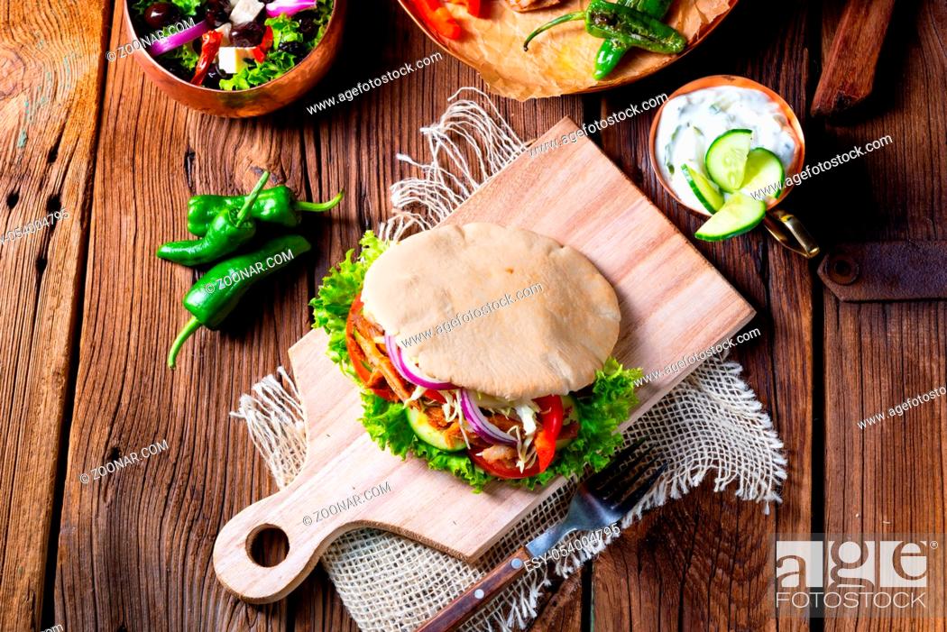 Stock Photo: Crunchy pita with grilled gyros meat. Various vegetables and garlic sauce.
