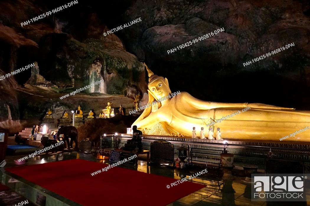 Stock Photo: 04 March 2019, Thailand, Takua Thung: A Buddha statue in the largest cave (""Tham Yai"") of Wat Suwan Kuha, also called Wat Tham (""cave temple"").