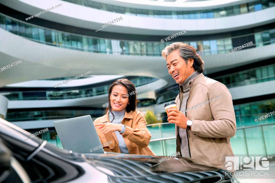 Stock Photo: Business people use computers in the outdoor.
