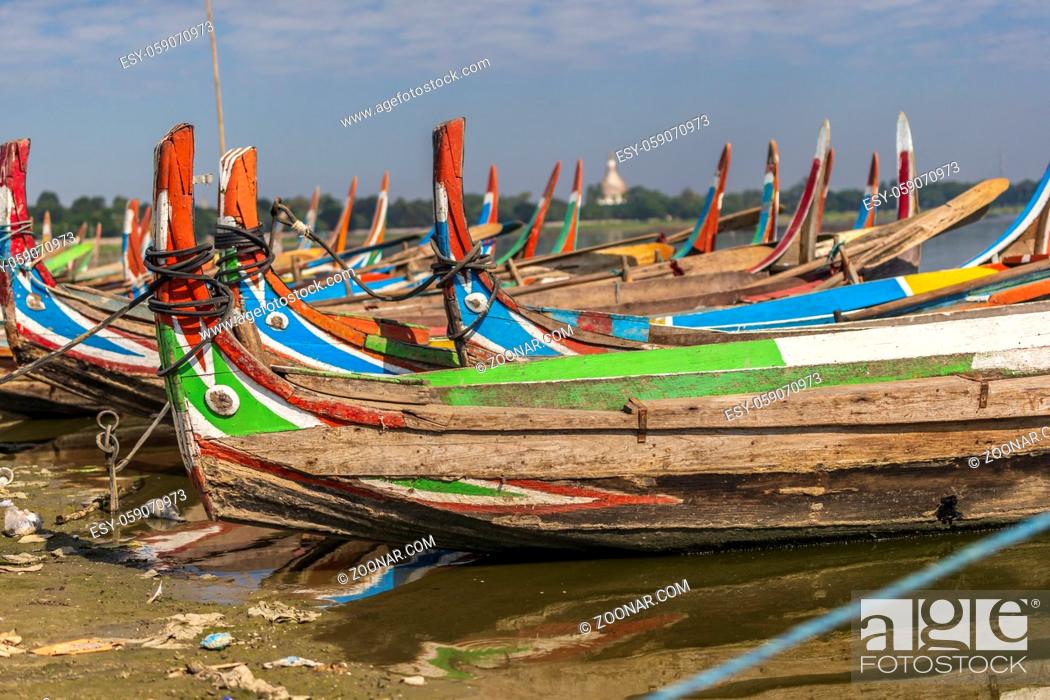 Stock Photo: Colourful boats in front of the U Bein bridge.