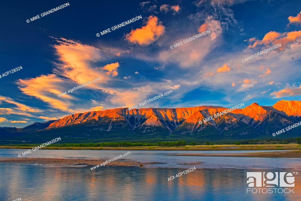 Stock Photo: Clouds reflected in Abraham Lake at sunrise. The Canadian Rocky Mountains. David Thompson Highway Alberta Canada.
