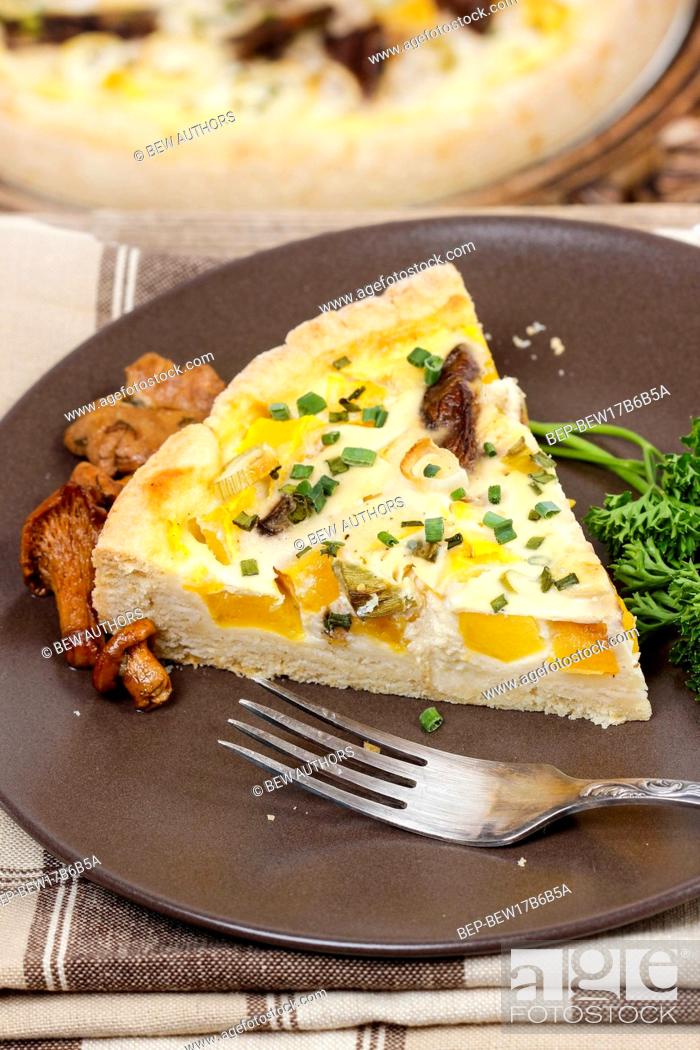 Stock Photo: Piece of quiche lorraine on brown plate. Autumn setting.