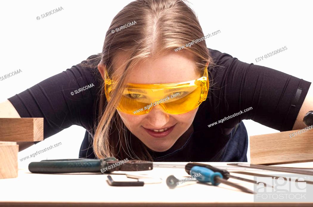 Stock Photo: close-up portrait of female construction worker with work desk.