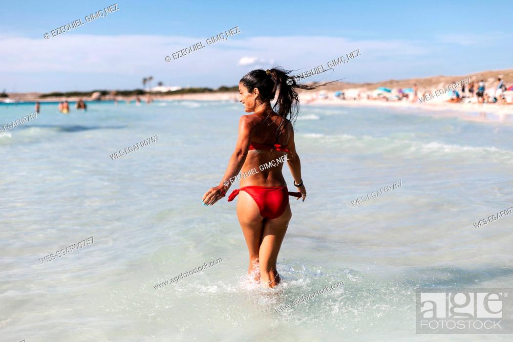 Boekhouder Riskant sectie Happy woman wearing bikini walking in sea against sky, Stock Photo, Picture  And Royalty Free Image. Pic. WES-EGAF00757 | agefotostock