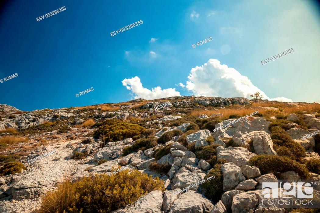 Stock Photo: Beautiful landscape with rocky mountains and clouds on the western part of Mallorca island, Spain. Tramuntana mountains with green bushes.