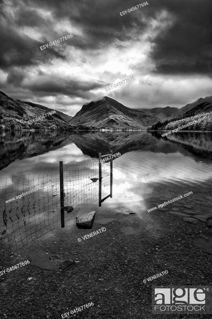 Stock Photo: Stunning black and white Autumn Fall landscape image of Lake Buttermere in Lake District England.