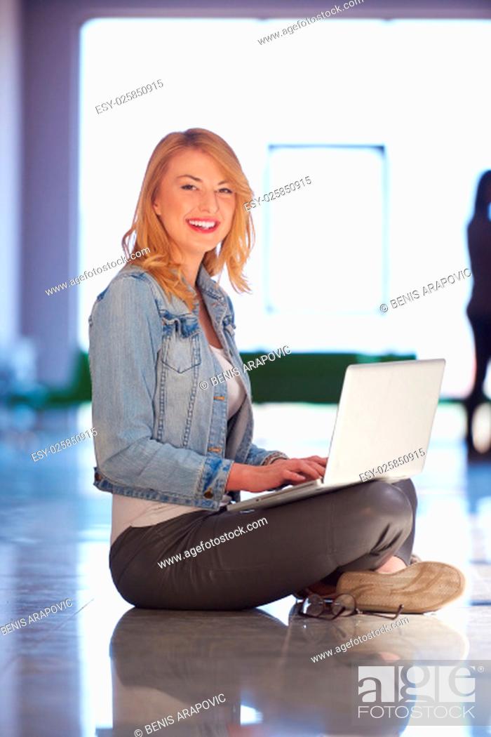 Stock Photo: happy student girl working on laptop computer at modern school university indoors.
