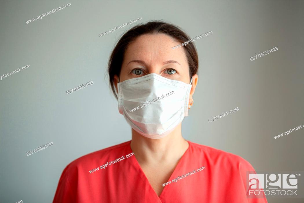 Stock Photo: Women doctor wearing protective mask to fight coronavirus pandemic covid-2019.