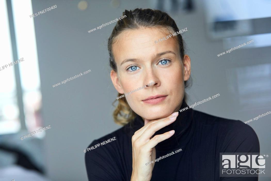 Stock Photo: Portrait of smiling young woman wearing black turtleneck.