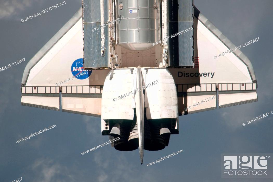 Stock Photo: This partial view of the wing and aft part of the payload bay of the space shuttle Discovery was provided by an Expedition 26 crew member during a survey of the.