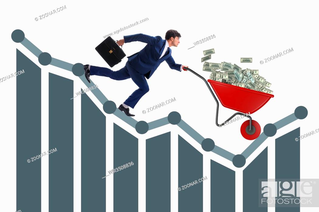 Stock Photo: Businessman pushing money wheelbarrow down the chart.