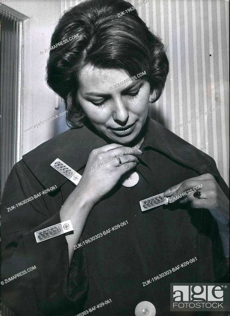 Stock Photo: Mar. 03, 1963 - Reflectors for pedestrians: 'Position-lights' this young lady has placed at her clothes. The Federal Traffic Service will start during this year.