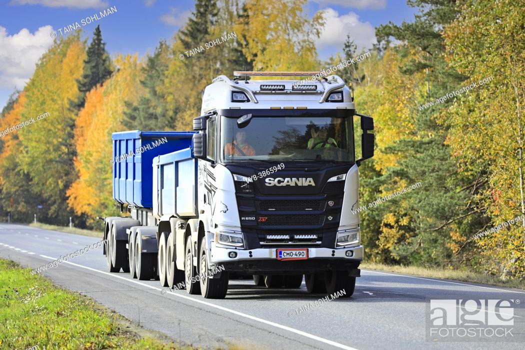 Stock Photo: Silver Scania R650 XT truck pulls gravel trailer along Highway 10 on a beautiful day of autumn. Tammela, Finland. October 2, 2020.
