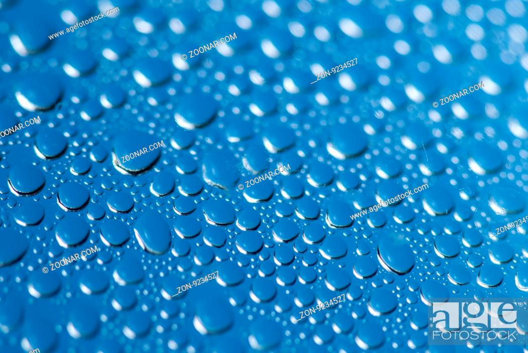 Stock Photo: close-up of water drops on the blue background.