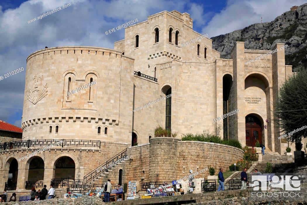 Stock Photo: Kruja Castle and Skanderbeg Museum exterior with tourist visitors and souvenir stalls in foreground.